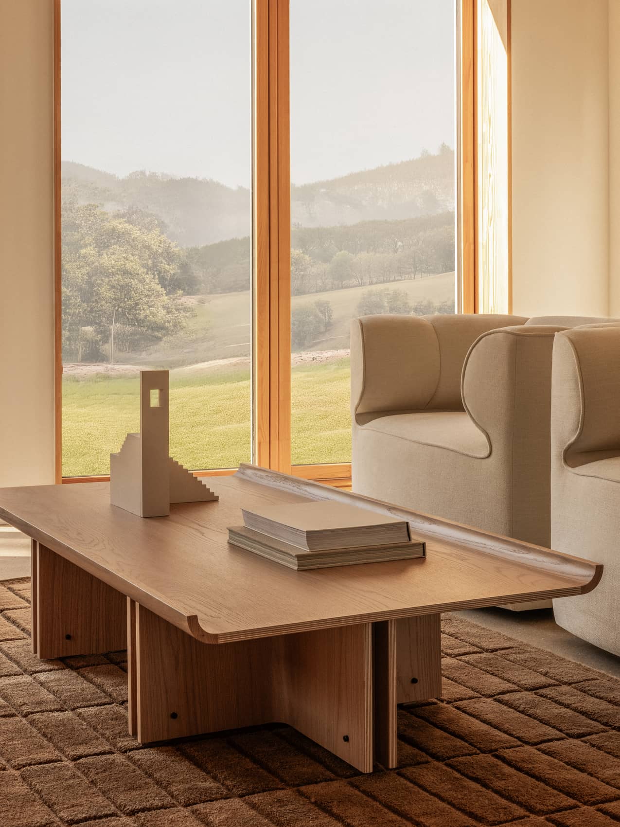 Eave Seamline Lounge Chair by Audo styled beside a lounge table and rug in front of a window – In Dubai by WSPR
