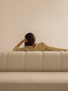 Eave Seamline Modular Sofa 86 4-Seater by Audo styled in a soft neutral room with a person resting along the backrest – In Dubai by WSPR