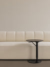 Eave Seamline Modular Sofa 86 4-Seater by Audo styled with a round side table against a plain neutral wall – In Dubai by WSPR