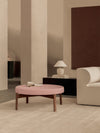 Passage Pouf by Audo styled in a warm living room with a pink seat, a table lamp and a curved sofa – In Dubai by WSPR