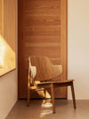 Penguin Wooden Lounge Chair by Audo styled beside a sunlit window and timber door – In Dubai by WSPR