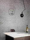 Hudson Wall/Ceiling Lamp by Audo styled above a marble table against a concrete wall – In Dubai by WSPR