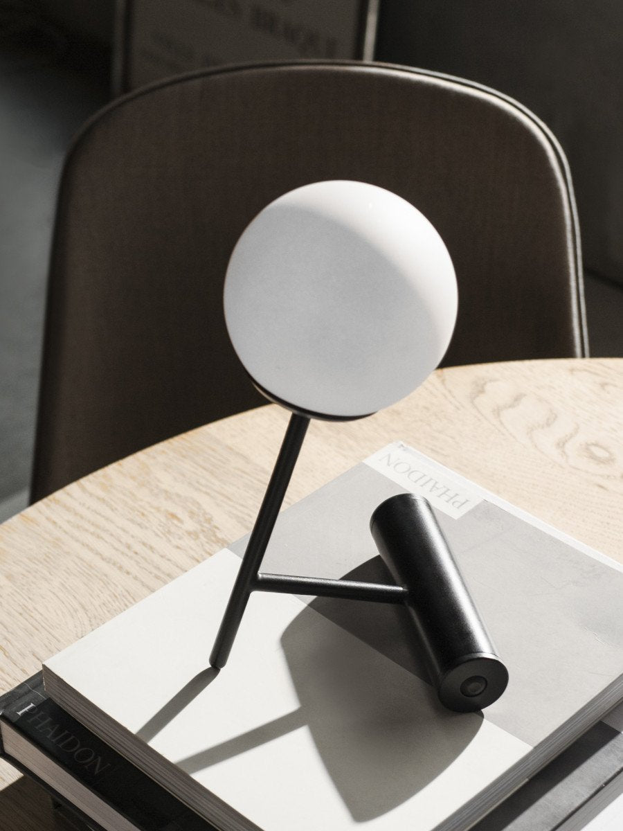 Phare Table Lamp by Audo styled on a round wooden table with books – In Dubai by WSPR