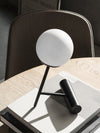 Phare Table Lamp by Audo styled on a round wooden table with books – In Dubai by WSPR