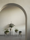 Daiza Planter by Audo styled in a plaster archway with a cluster of potted plants – In Dubai by WSPR