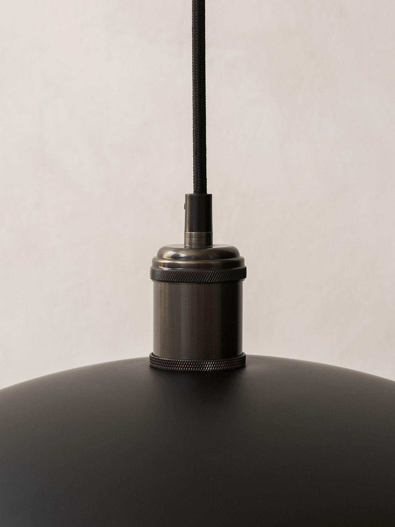 Hubert Pendant Ø45 by Audo, close-up of the bronzed brass fixture and black cord – In Dubai by WSPR