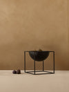 Kubus Bowl by Audo styled on a plinth against a warm plaster wall, with figs – In Dubai by WSPR