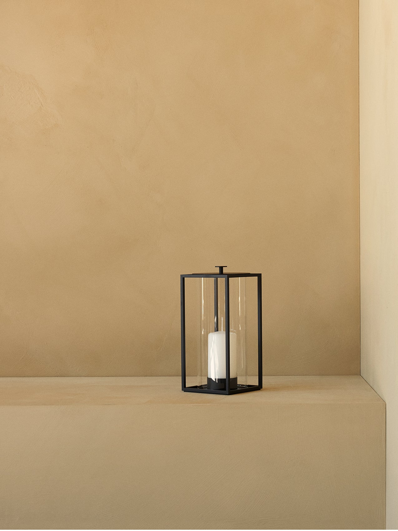 Light'In Lantern by Audo styled on a warm sand-coloured ledge – In Dubai by WSPR