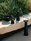 Meira Oil Lantern by Audo styled on a stone ledge among garden planting – In Dubai by WSPR