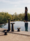Meira Oil Lantern by Audo styled in a group beside an infinity pool at dusk – In Dubai by WSPR
