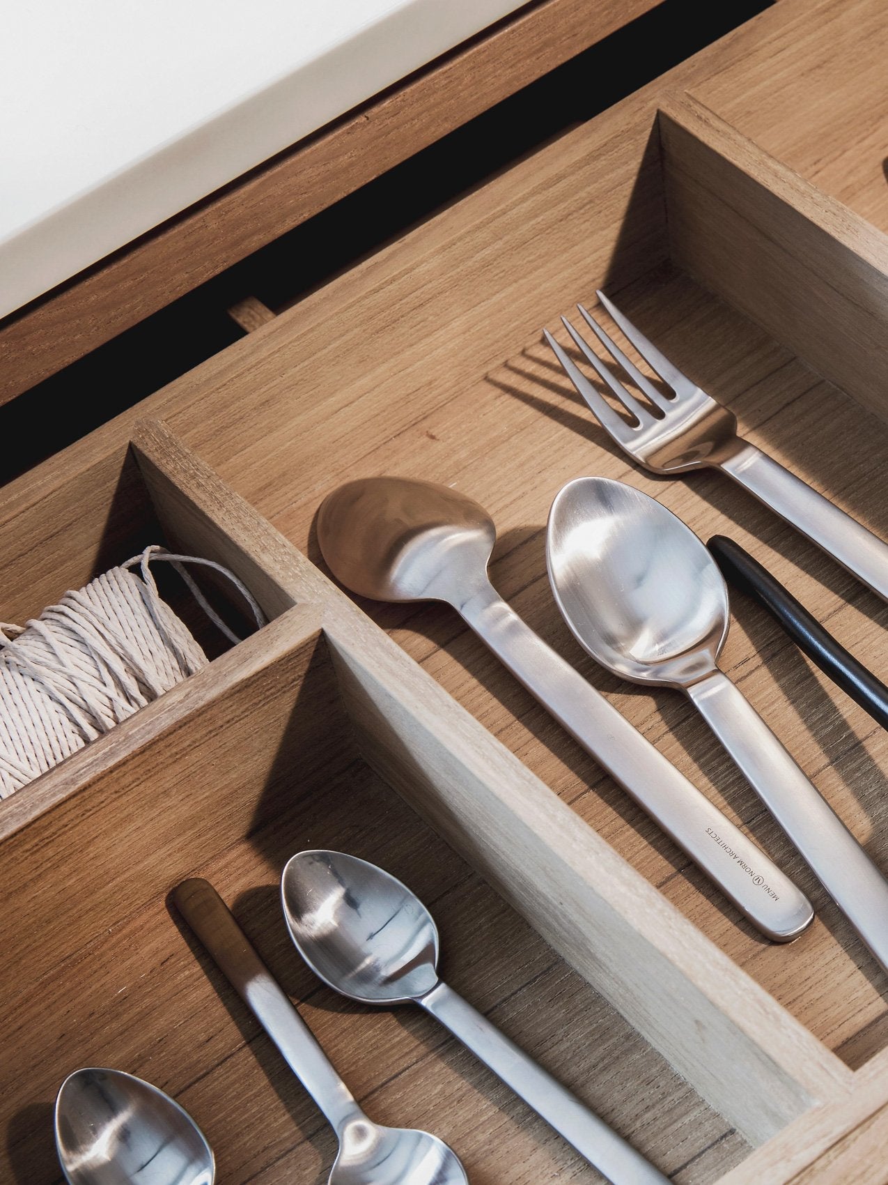 New Norm Flatware by Audo styled on a pale oak surface with a knife, fork and spoons – In Dubai by WSPR