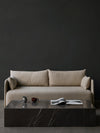 Plinth Table Grand by Audo styled in front of a sofa against a dark wall, with a magazine and small pots – In Dubai by WSPR