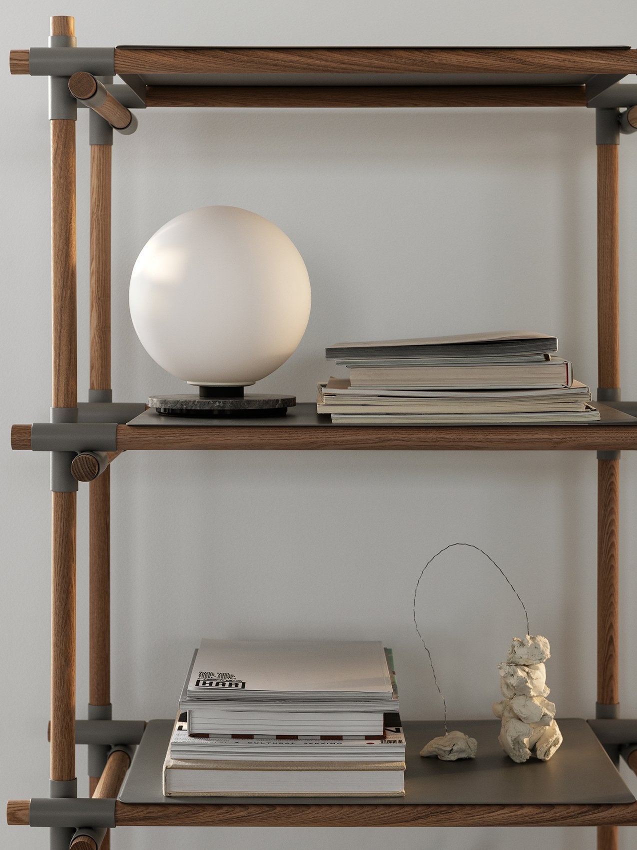TR Bulb Table/Wall Lamp by Audo styled on a timber shelving system beside books – In Dubai by WSPR
