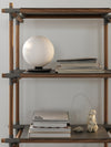 TR Bulb Table/Wall Lamp by Audo styled on a timber shelving system beside books – In Dubai by WSPR