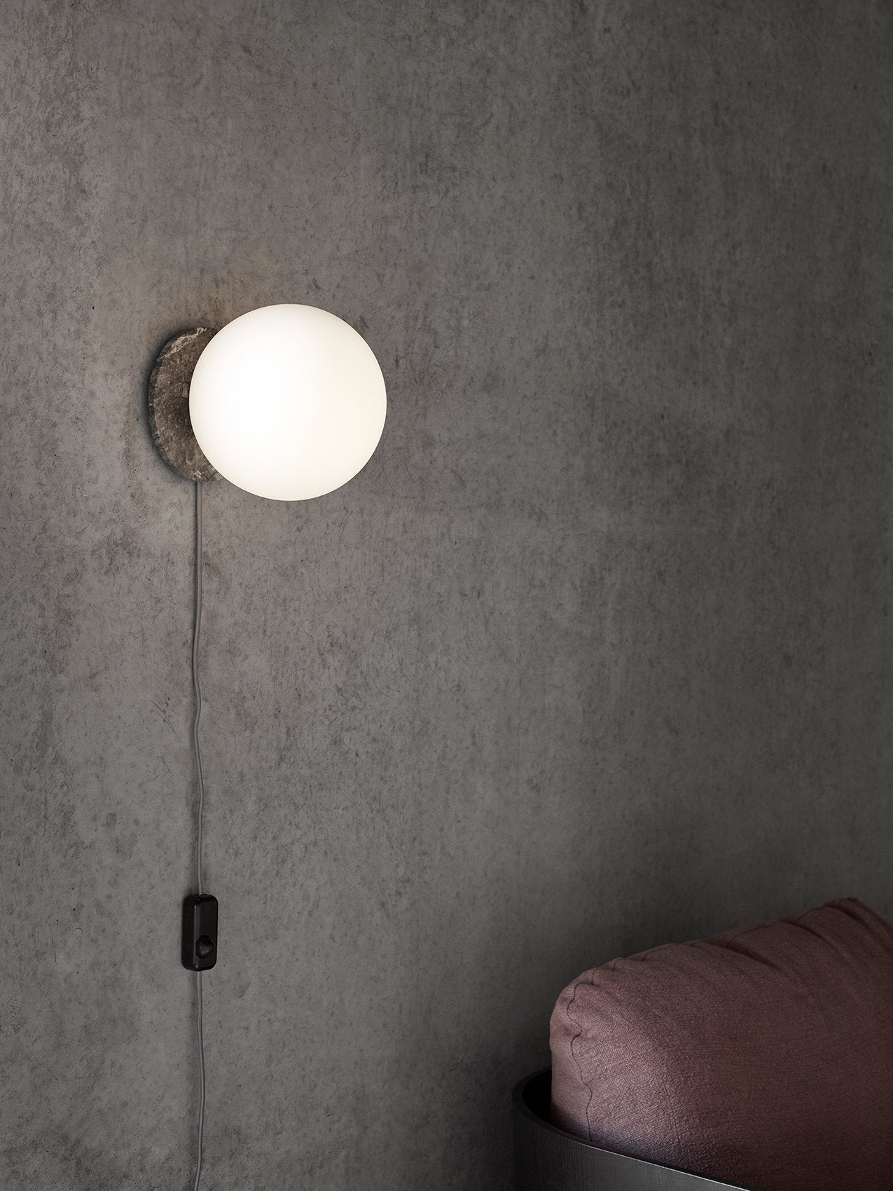 TR Bulb Table/Wall Lamp by Audo styled as a wall light on a concrete wall – In Dubai by WSPR