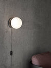 TR Bulb Table/Wall Lamp by Audo styled as a wall light on a concrete wall – In Dubai by WSPR