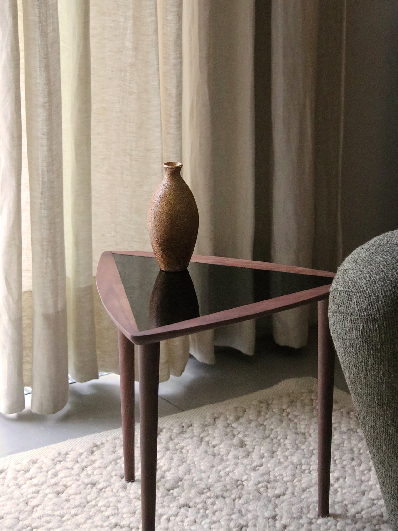 Umanoff Nesting Side Table by Audo styled beside an upholstered armchair with a walnut vase and soft curtains – In Dubai by WSPR