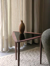 Umanoff Nesting Side Table by Audo styled beside an upholstered armchair with a walnut vase and soft curtains – In Dubai by WSPR