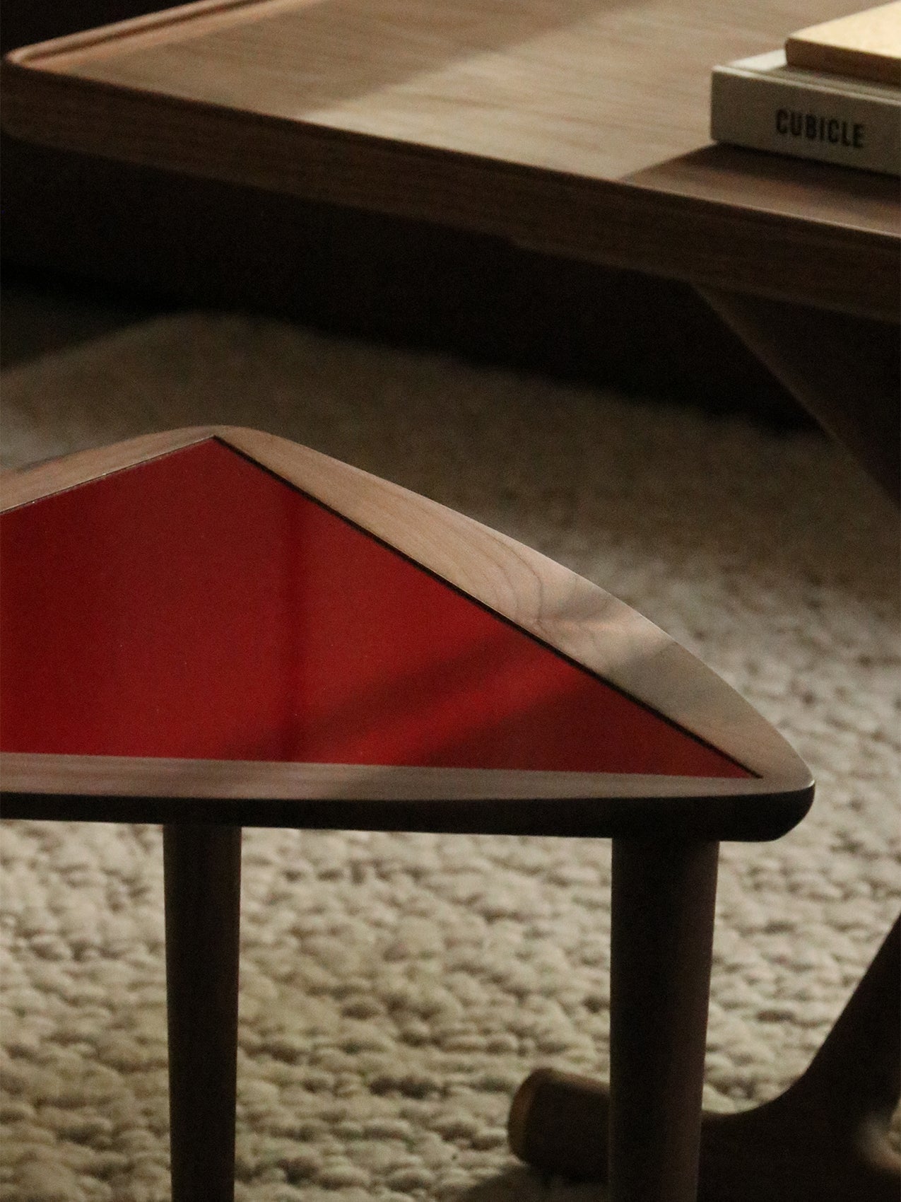 Umanoff Nesting Side Table by Audo styled on a textured rug, close-up of the burgundy laminate top – In Dubai by WSPR