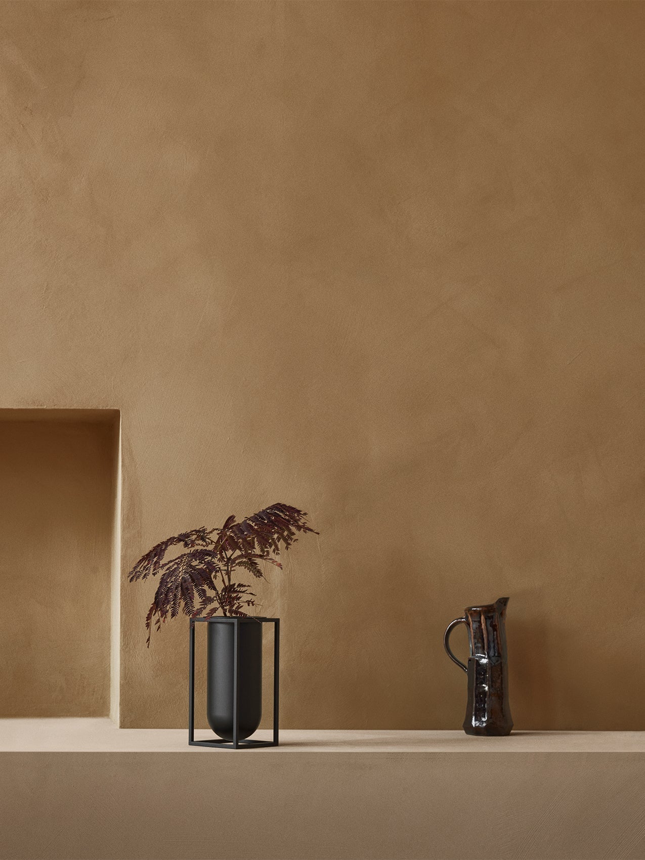 Kubus Vase Lolo by Audo styled on a plaster ledge with dark foliage – In Dubai by WSPR