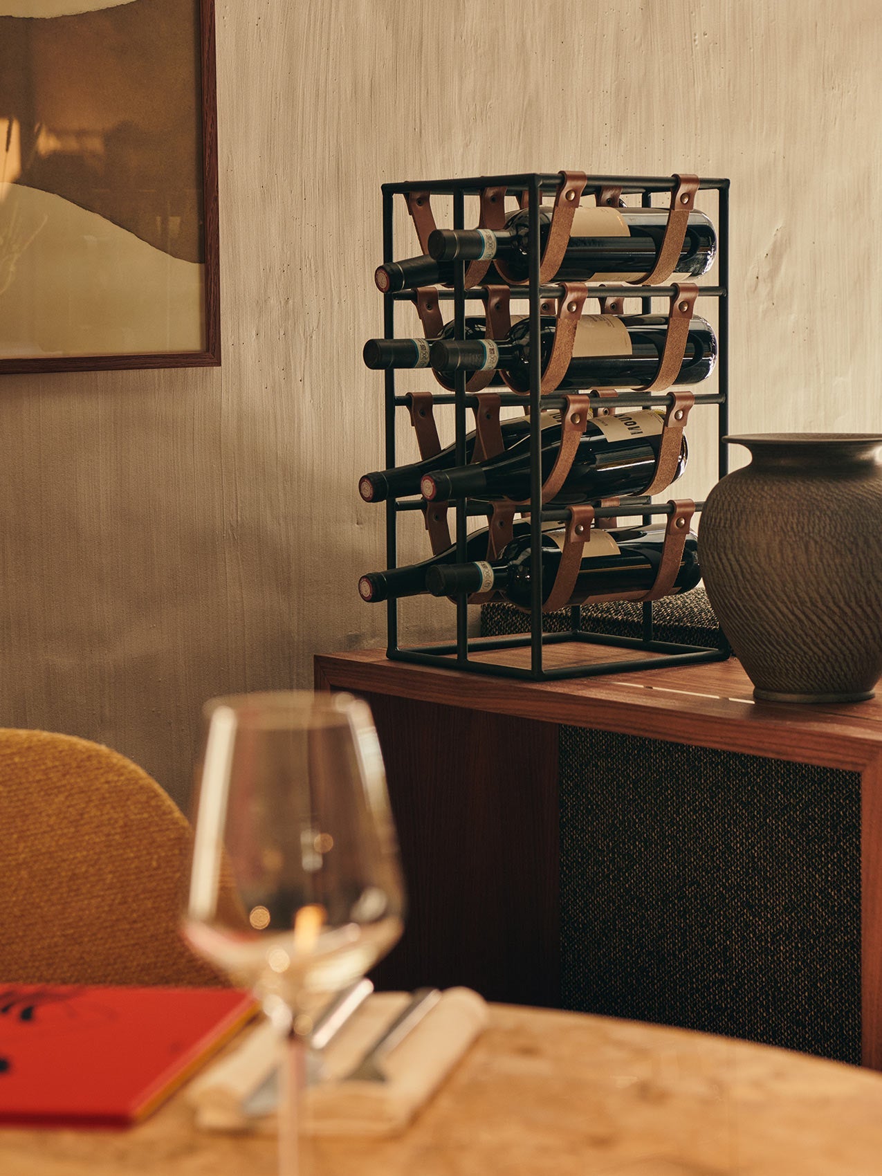 Umanoff Wine Rack by Audo styled on a wooden table beside a wine glass and a dark vase – In Dubai by WSPR