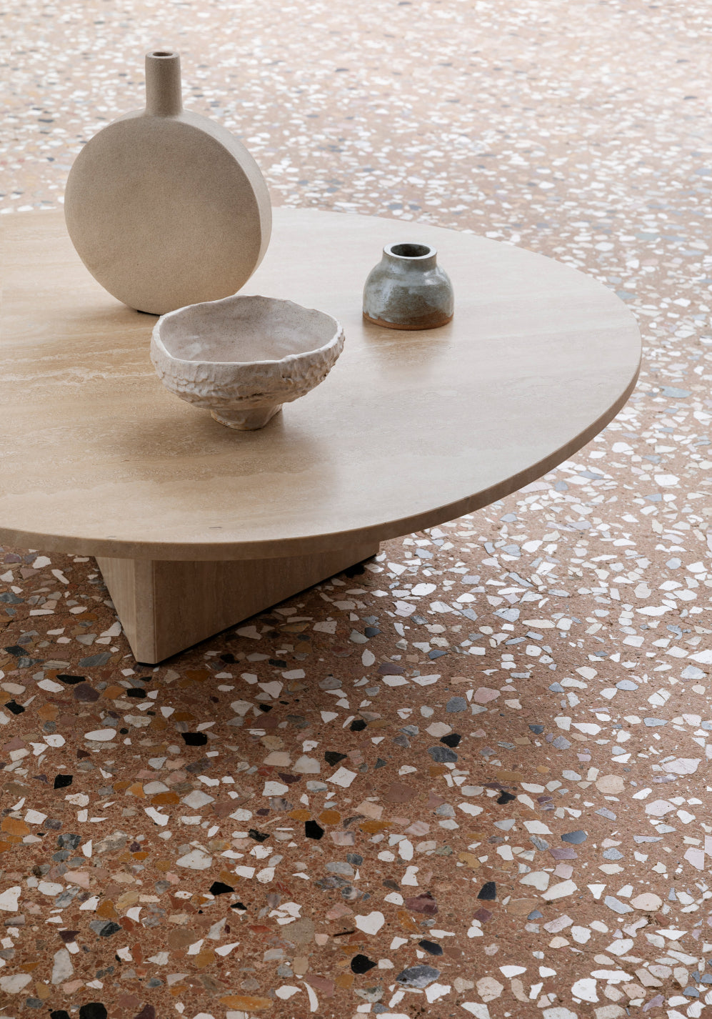 Albio Coffee Table by Miniforms in travertine on a terrazzo floor – In Dubai by WSPR