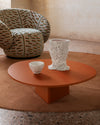 Albio Coffee Table by Miniforms in a burnt-orange lacquered finish, styled beside an armchair – In Dubai by WSPR