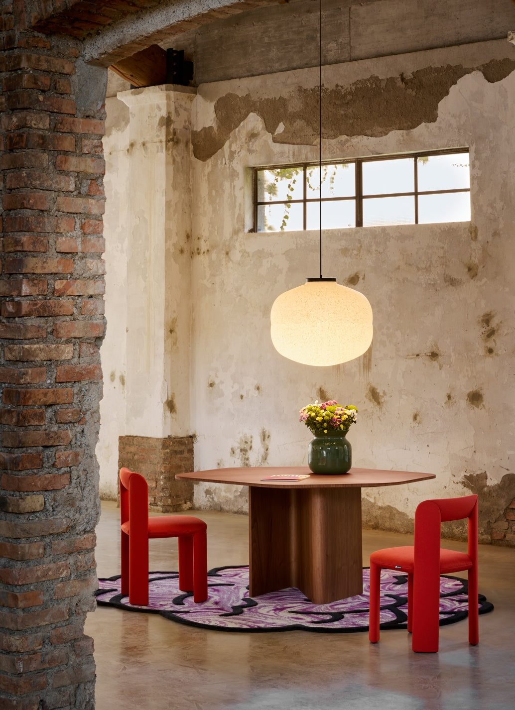 Baso Pendant Lamp by Miniforms styled above a round dining table in a restored brick interior – In Dubai by WSPR