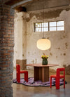 Baso Pendant Lamp by Miniforms styled above a round dining table in a restored brick interior – In Dubai by WSPR