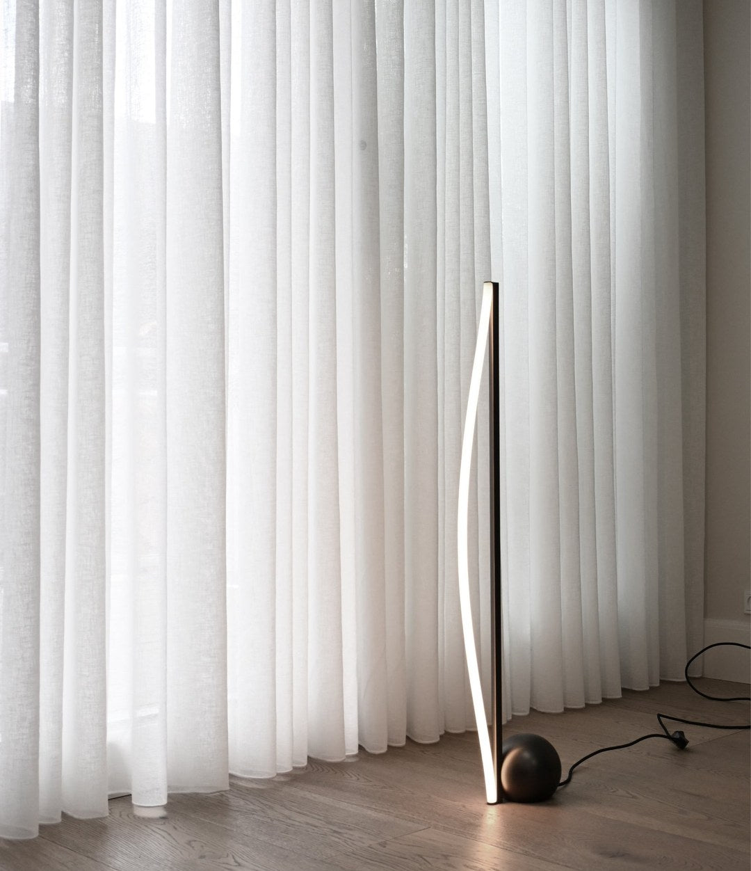 Bow Floor Lamp by 101 Copenhagen in Bronze in a styled interior – In Dubai by WSPR