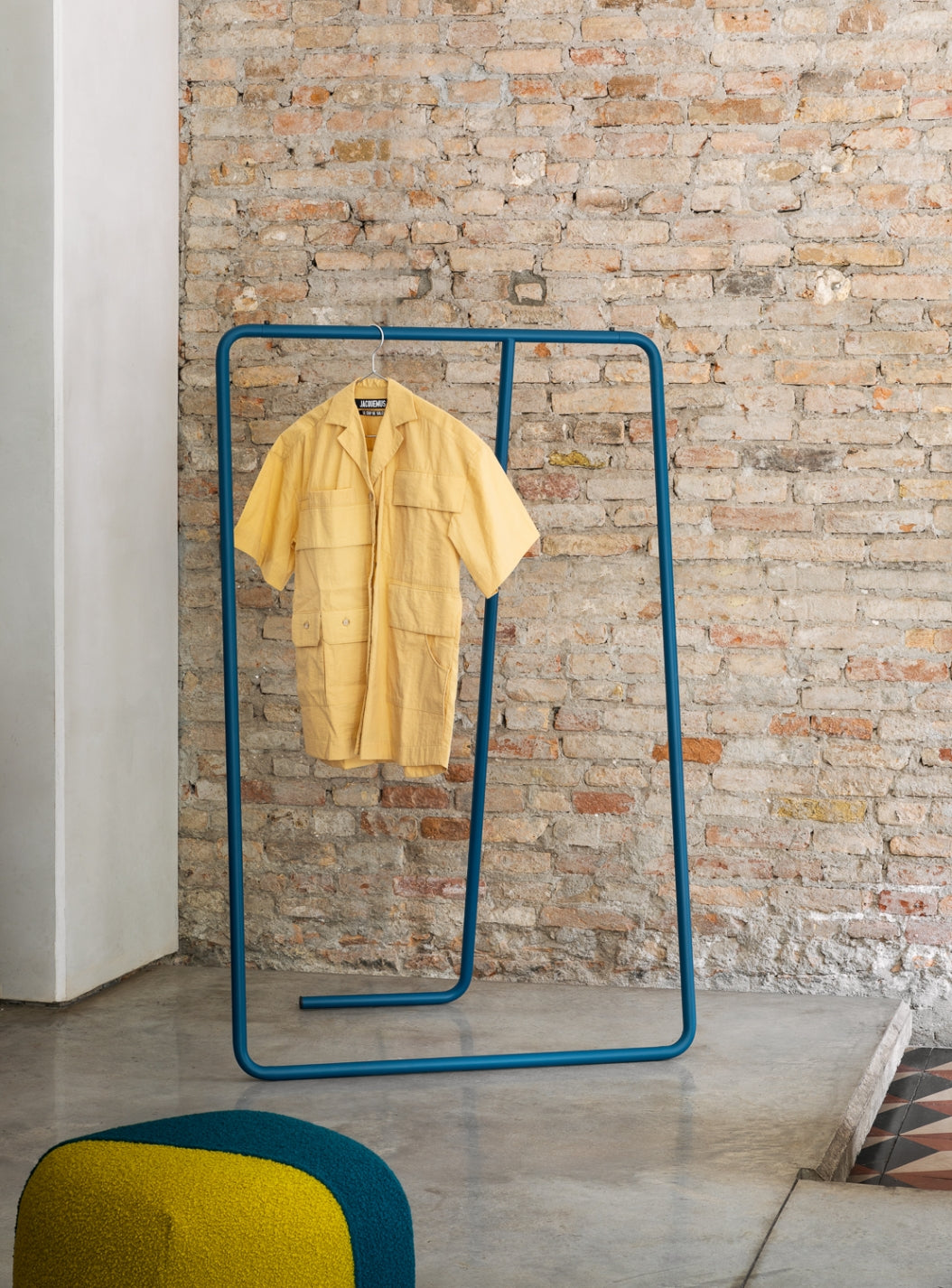 Caio Coat Rack by Miniforms styled against a brick wall with a shirt on the frame – In Dubai by WSPR