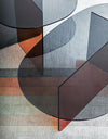 Chap Coffee Table by Miniforms in orange and grey glass, styled on a rug against a white wall – In Dubai by WSPR