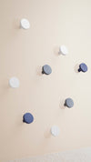 Chiodo Hanger by Miniforms styled as a scattered arrangement of pegs on a soft pink wall – In Dubai by WSPR