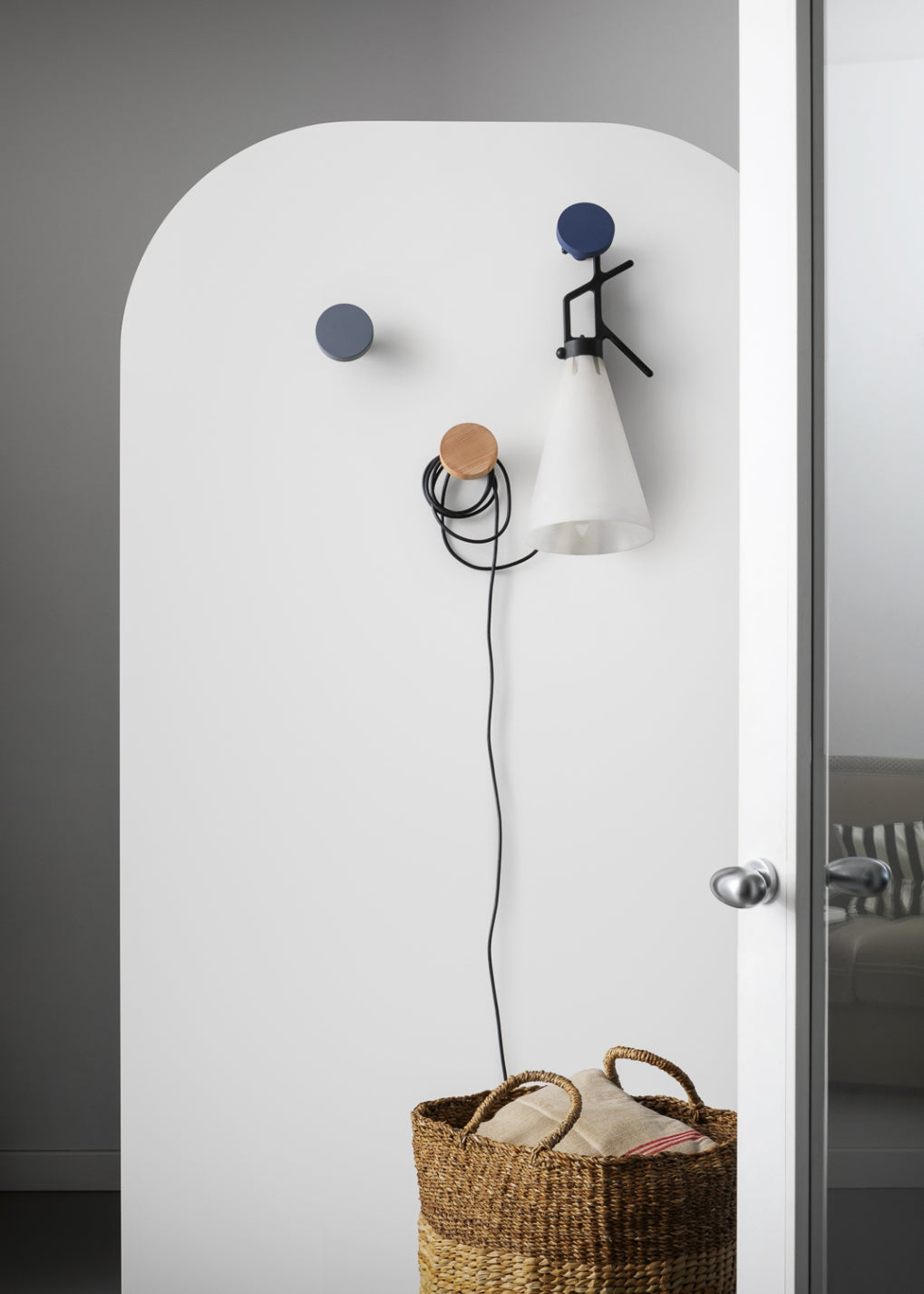 Chiodo Hanger by Miniforms styled in an entrance with pegs holding a lamp and a basket – In Dubai by WSPR
