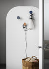Chiodo Hanger by Miniforms styled in an entrance with pegs holding a lamp and a basket – In Dubai by WSPR