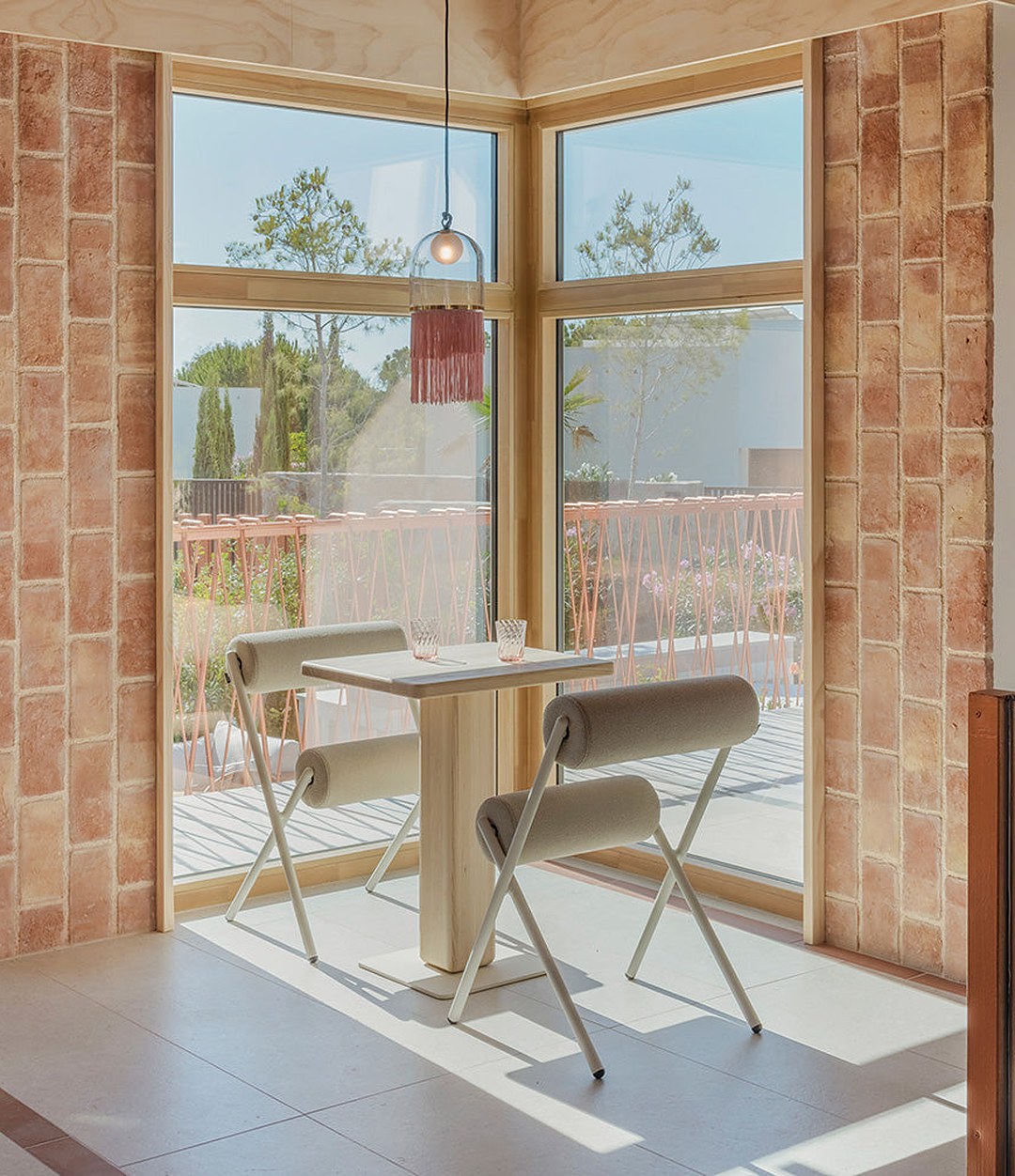 Cita Bistro Table by Sancal with chairs by a window – In Dubai by WSPR