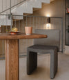 Cita Bistro Table by Sancal with a stool by a staircase – In Dubai by WSPR