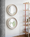 Coque Mirror by Miniforms styled as a pair on a white wall beside timber shelving – In Dubai by WSPR