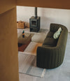 Core Sofa by Sancal in dark green by a stove – In Dubai by WSPR