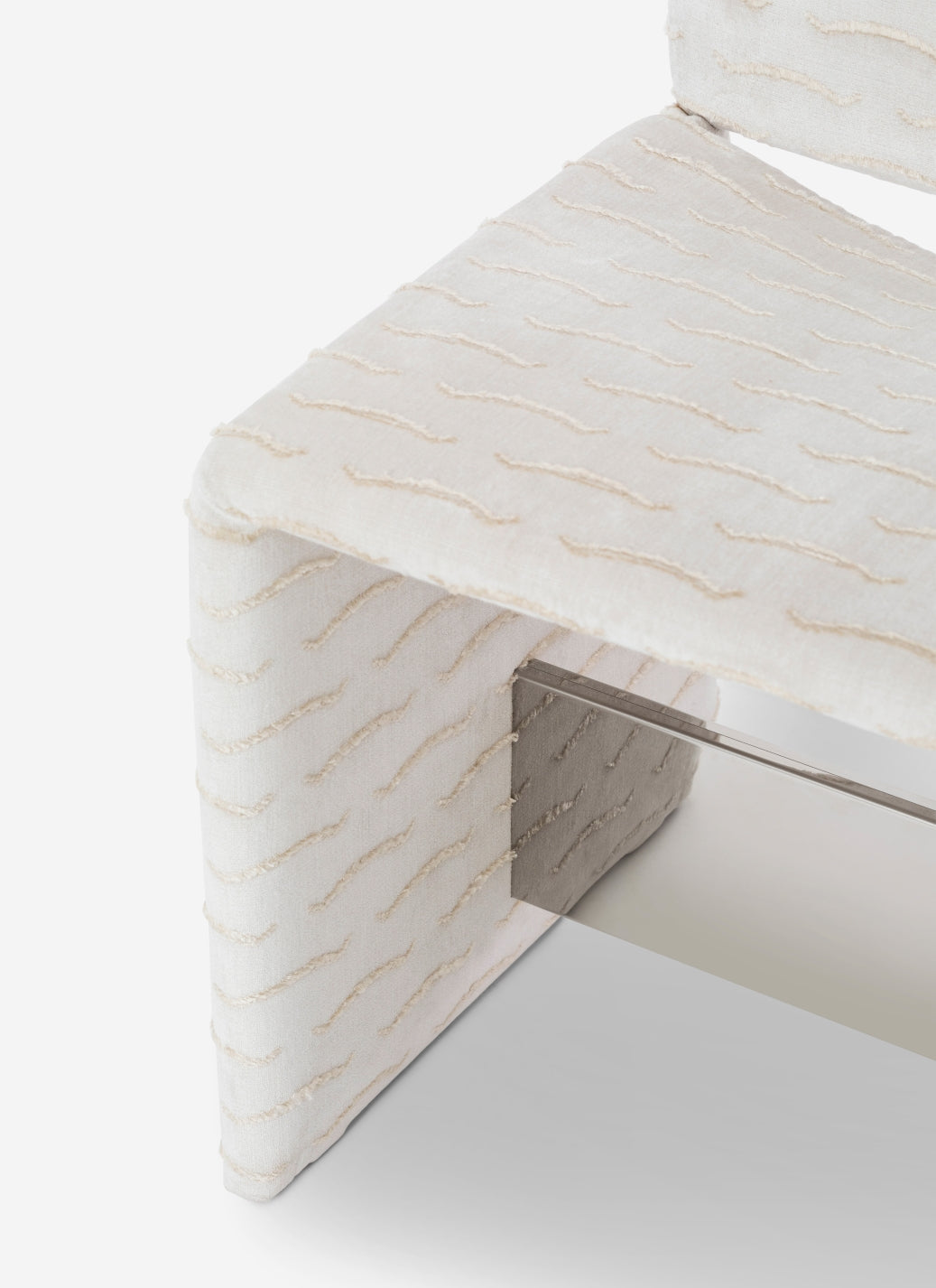 Cubola Chair by Miniforms in cream textured fabric with a mirrored crossbar, three-quarter view – In Dubai by WSPR