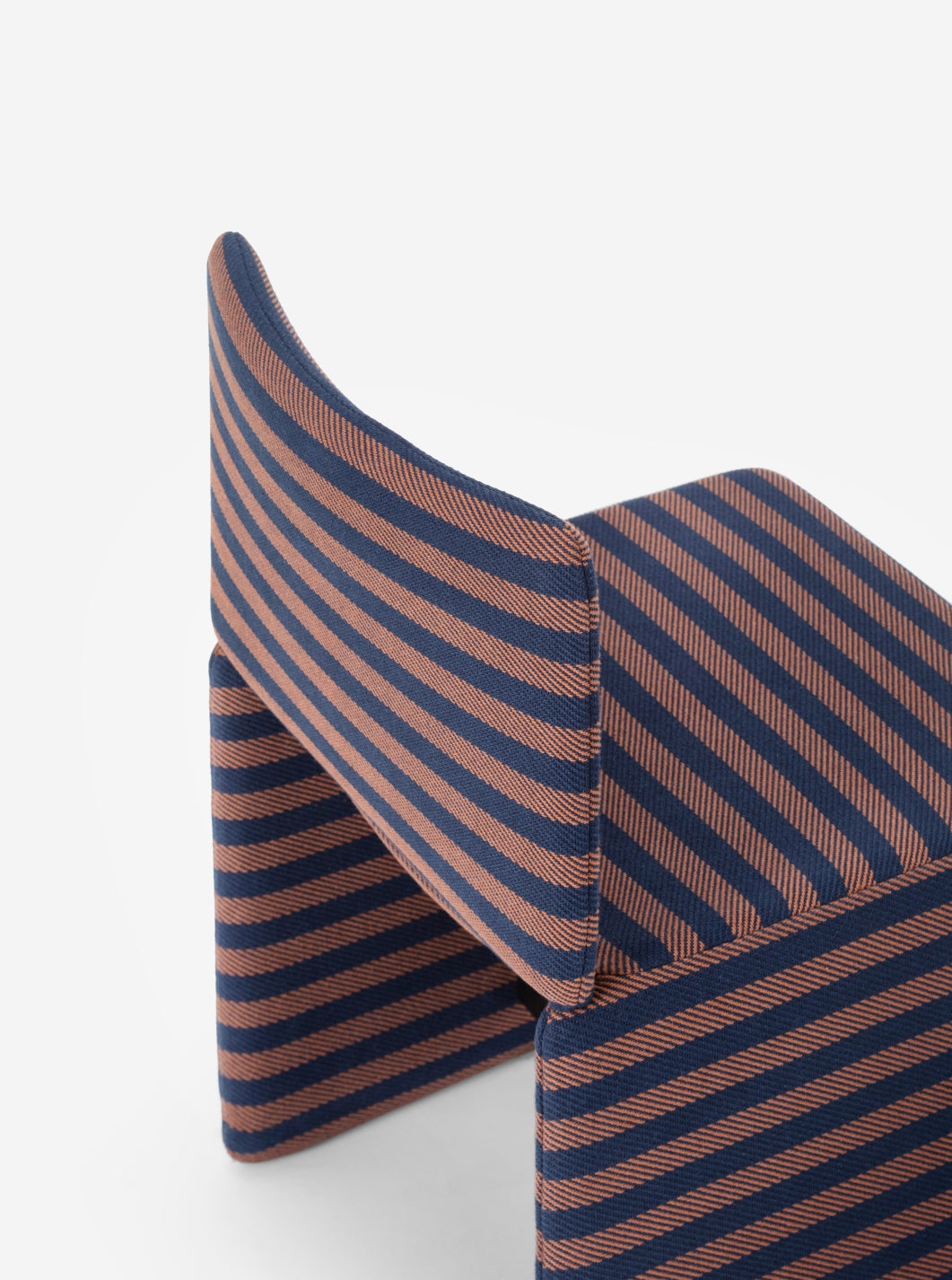 Cubola Chair by Miniforms in striped fabric, three-quarter view showing the curved backrest – In Dubai by WSPR