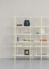 Cuoppo Vase by Miniforms in Blu baked clay, styled on a cream shelving unit with books – In Dubai by WSPR