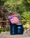 Cuoppo Vase by Miniforms in Blu baked clay, styled with hydrangeas on a timber table outdoors – In Dubai by WSPR