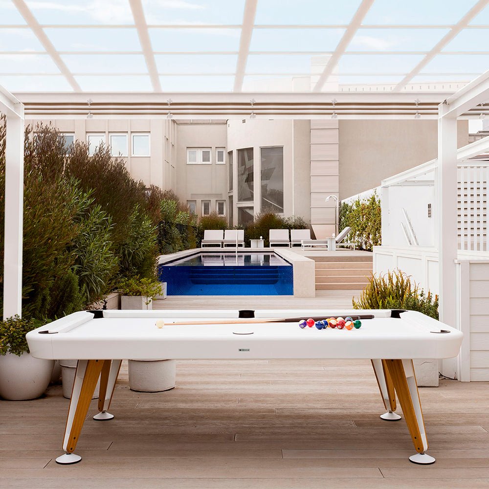 Diagonal Pool Table (Outdoor) by RS Barcelona in Traffic White on a terrace by a pool – In Dubai by WSPR