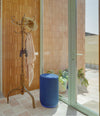 Dividuals Pouf by Sancal tall round pouf in blue by a door – In Dubai by WSPR