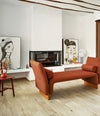 Diwan Bench by Sancal divan with arms by a fireplace – In Dubai by WSPR