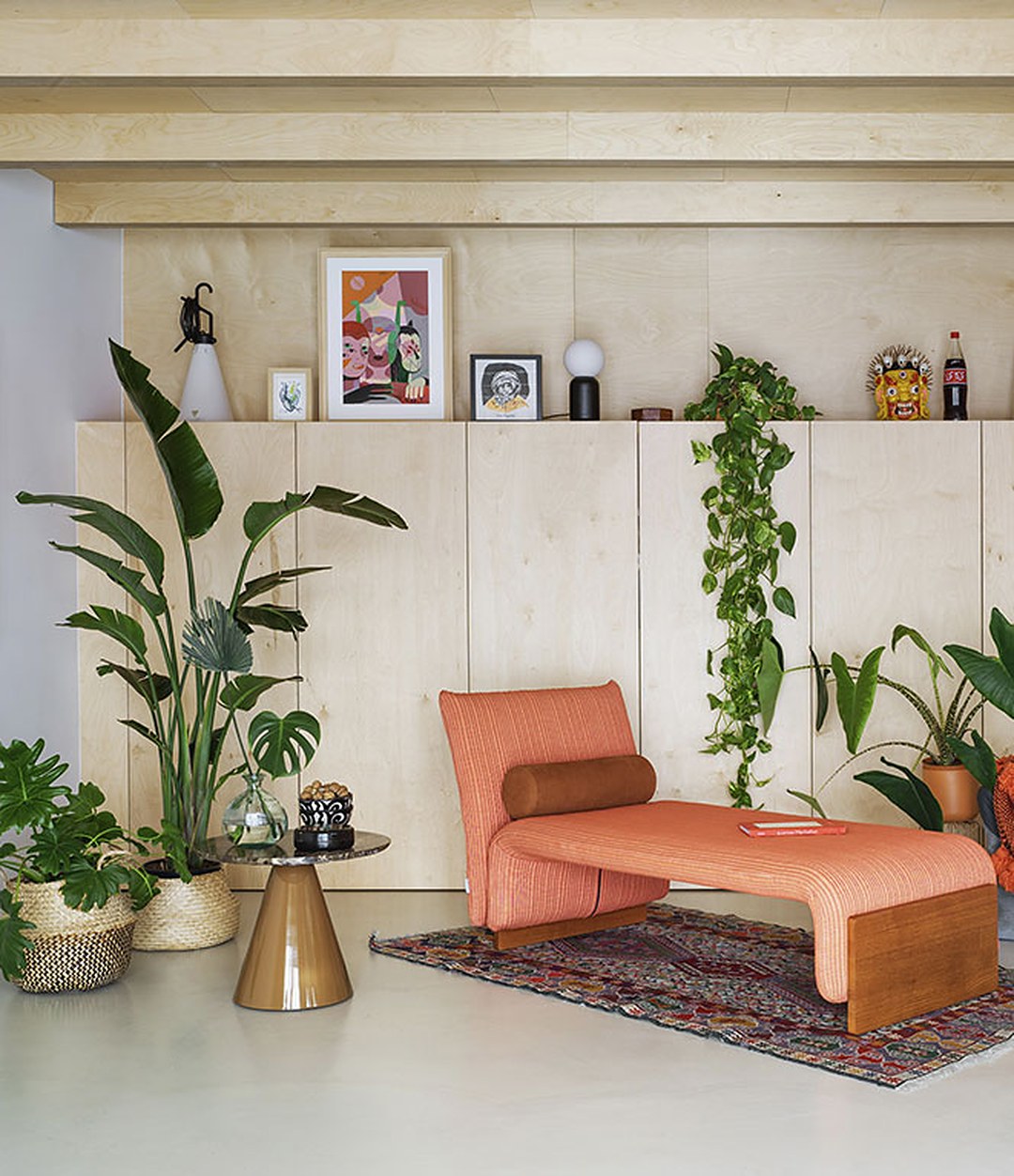 Diwan Chaise Longue by Sancal in coral in a plant-filled room – In Dubai by WSPR