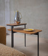 Duplex Coffee Table by Sancal in walnut by a concrete wall – In Dubai by WSPR