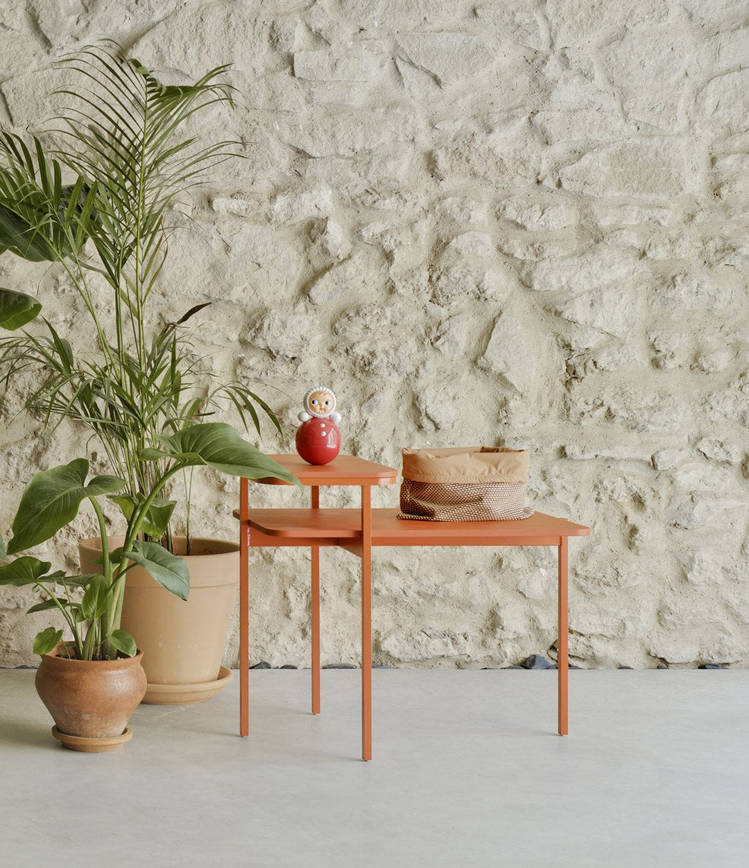 Duplex Coffee Table by Sancal in terracotta against a stone wall – In Dubai by WSPR