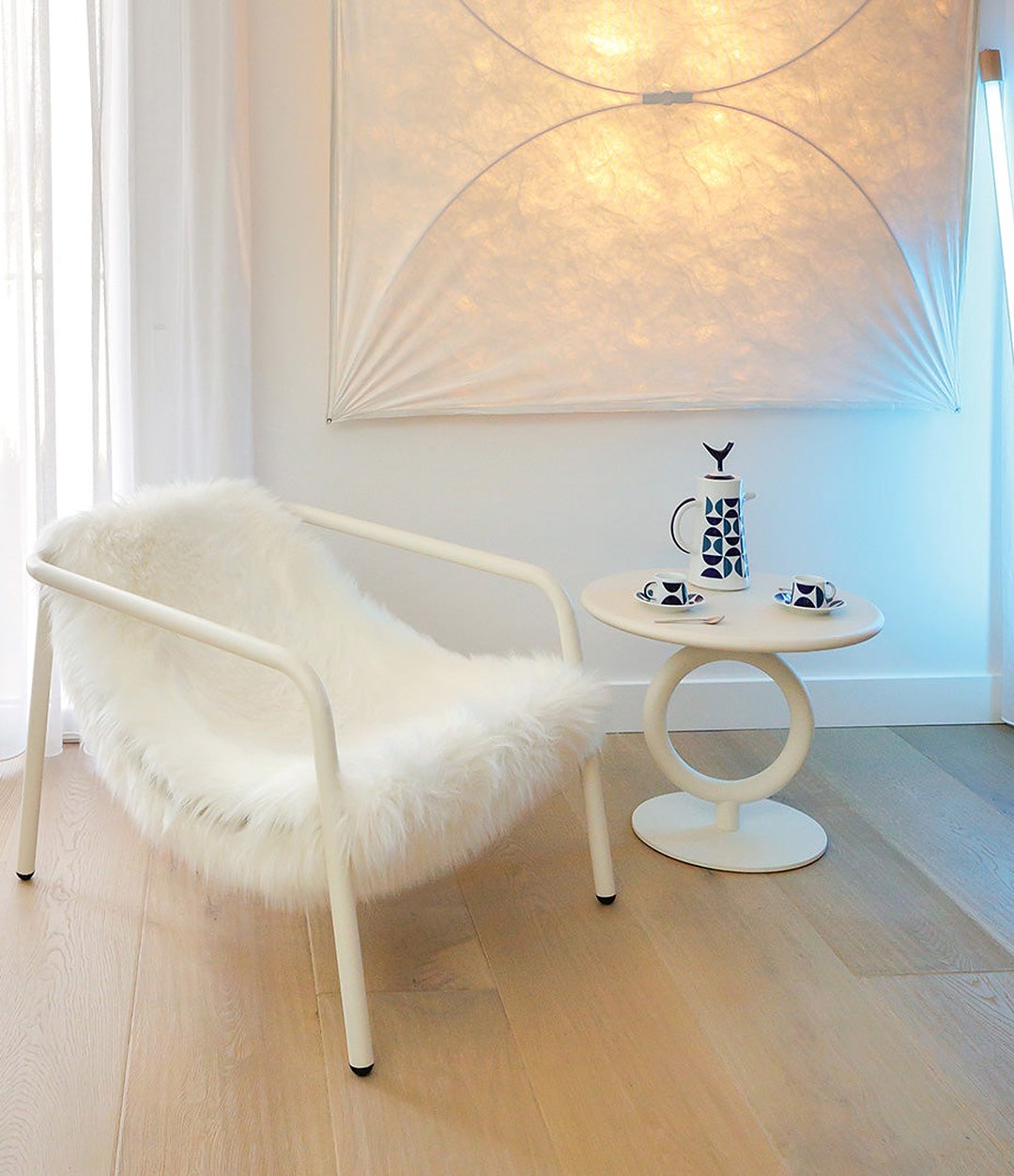 Elle Mini Lounge Chair by Sancal in white by a window – In Dubai by WSPR